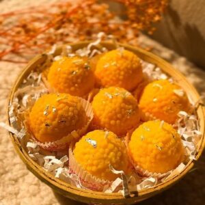 Handmade Motichoor Laddoo-shaped candles crafted from eco-friendly soy wax — ideal for festive décor, gifting, and puja setups.